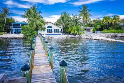 a house on the water with a dock at Keys Oceanfront Beauty Dock and pool in Marathon