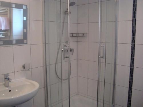 a bathroom with a shower and a sink at Hotel Gartenhof in Mühlheim