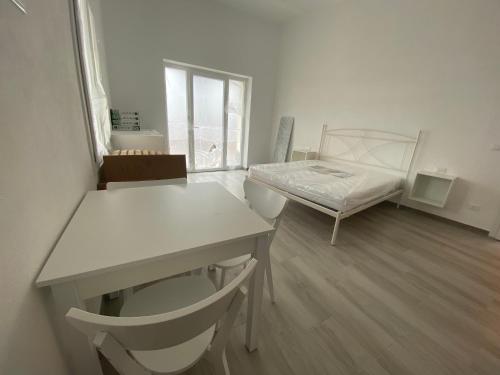 a room with a bed and a desk and a table at VILLA IRMA in Varigotti