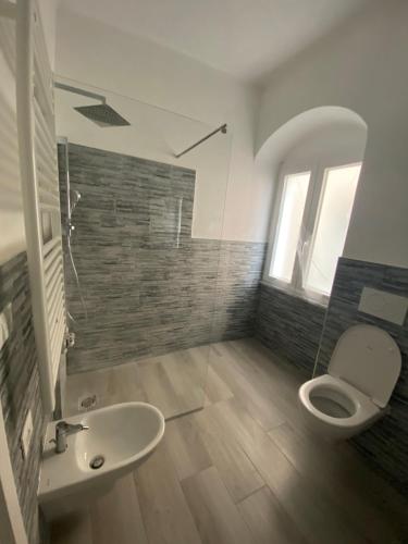 a bathroom with a toilet and a sink at VILLA IRMA in Varigotti