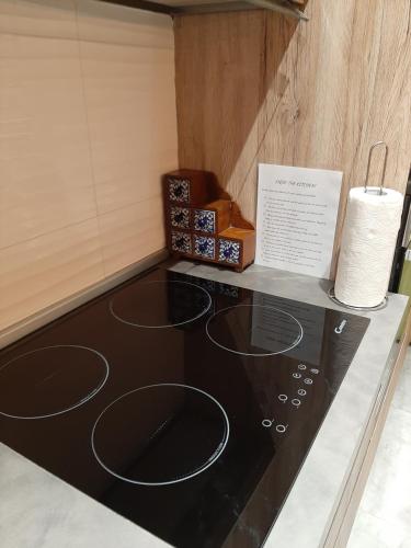 a kitchen counter with a black stove top oven at QLiving Central New Apartments Gzira Sliema Promenade in Il-Gżira