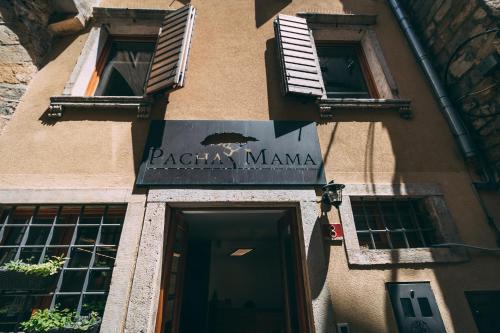 a building with a sign for a pizza manma at Guest House PachaMama in Piran