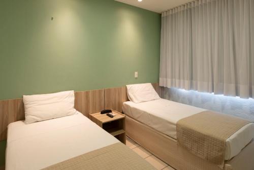 Hotel Vila Leste tesisinde bir odada yatak veya yataklar