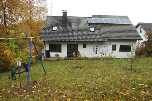 a house with a yard with a swing at Bergblick in Medebach