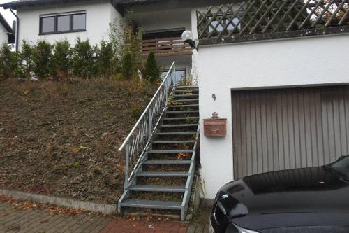 a staircase leading up to a house with a garage at Bergblick in Medebach