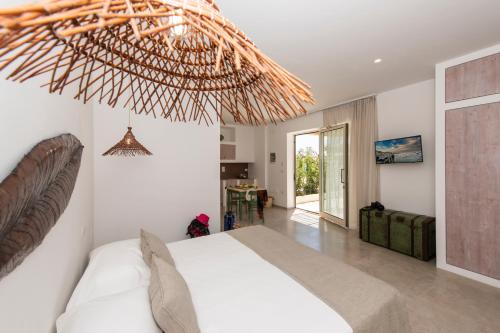 a bedroom with a bed and a large ceiling at Livantea Agriresort e Residence in Otranto
