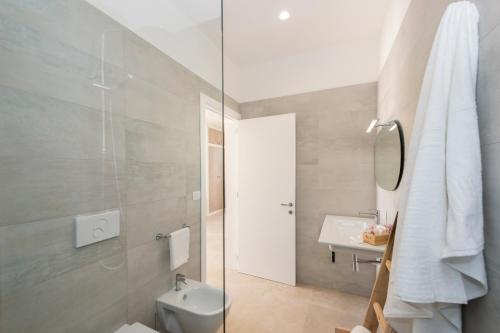 a bathroom with a shower and a toilet and a sink at Livantea Agriresort e Residence in Otranto