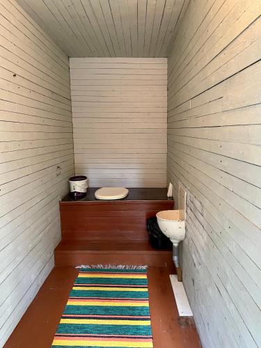 a small bathroom with a toilet and a rug at KTU Kuntomaja in Kokkola