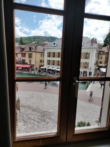 a view of a city from a window at Hotel de Savoie in Annecy
