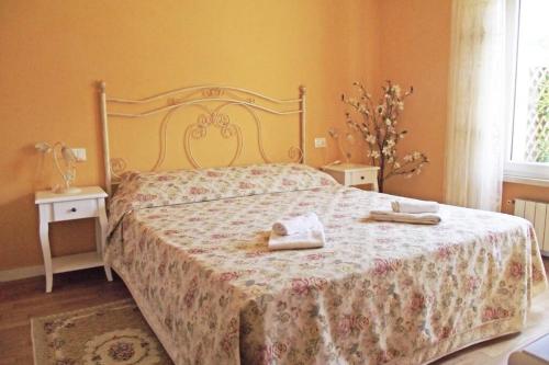 a bedroom with a bed with two towels on it at Il Gioiellino in Lucca