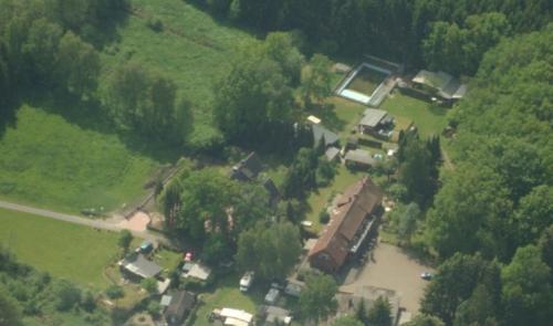 an aerial view of a house with a river at Pension Im Rehwinkel in Soltau