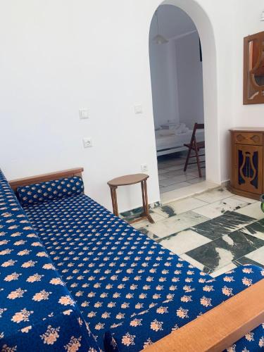 a bed in a room with a blue comforter at Vino suites in Agia Anna Naxos