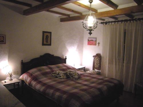 a bedroom with a bed with a checkered blanket at Casa Elisa in Bibbiena