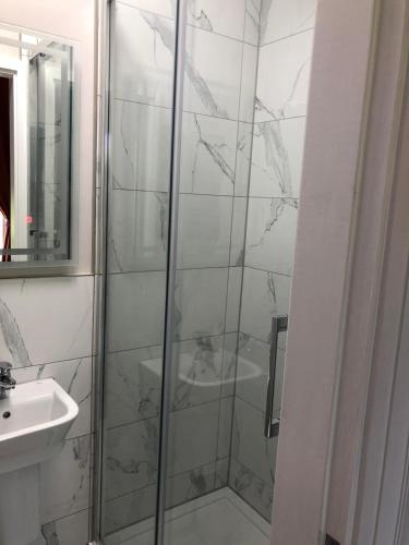 a bathroom with a shower and a sink at Winckley Square Residences in Preston