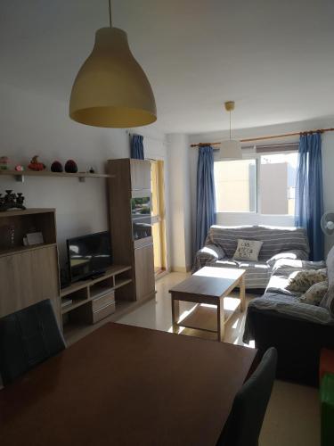 a living room with a couch and a table at Paraiso alquiler vacacional in Málaga