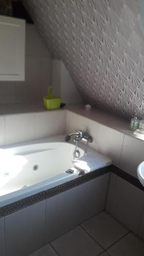 a bathroom sink with a faucet on a counter at Au cottage normand in Saint-James