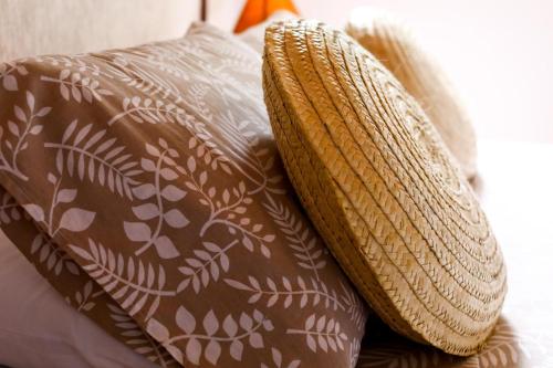 two pillows sitting on top of a bed at Hospedaria Tayrona in Lençóis