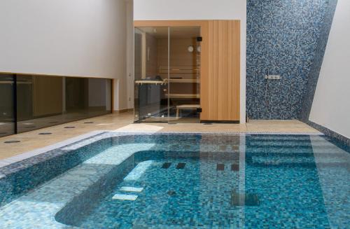 a bathroom with a swimming pool in a house at Villa Nai 3.3 in Žman