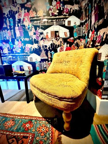 a room with a yellow ottoman sitting on a rug at Luxurious, Fabulous, Fun, Contemporary Suite in Retreat Centre in Salisbury