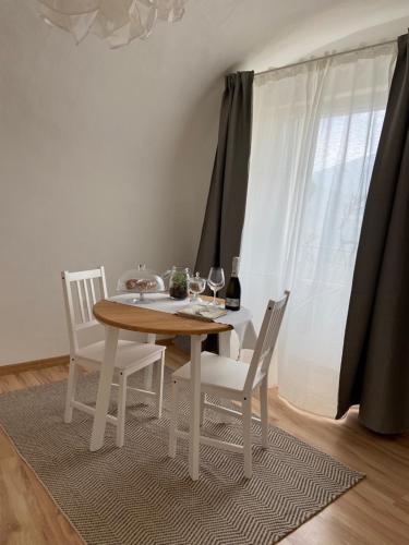 a dining room table and chairs with wine glasses on it at B&B L'edera in Trento