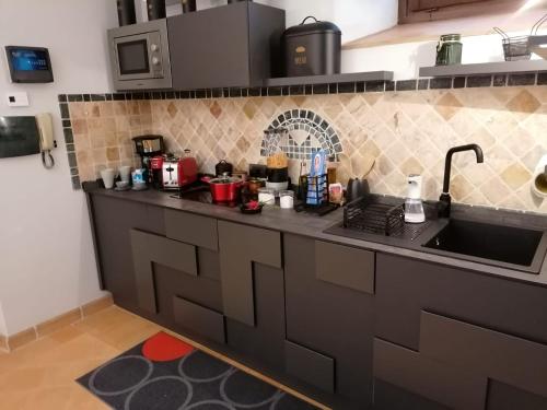 a kitchen with a sink and a counter top at La perla nel pozzo in Orvieto