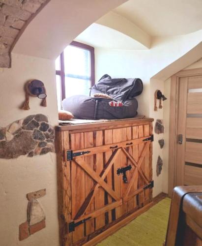 a room with a large wooden chest with a window at HelloVilniusHostel in Vilnius