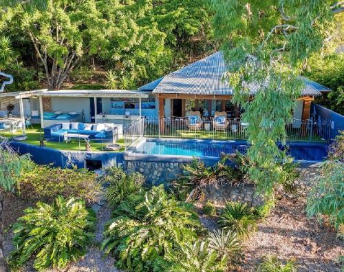 an aerial view of a house with a swimming pool at Beachfront Peace Cabin in Oak Beach