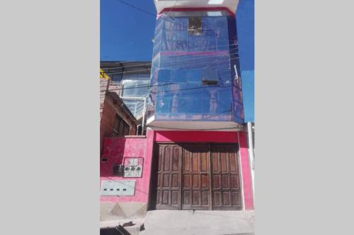 a building that is under construction with a wooden door at Calor De Hogar Con Altura in Potosí