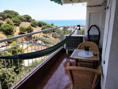 a balcony with a table and chairs and the ocean at Bonavista Studio with a Balcony - Calella in Calella