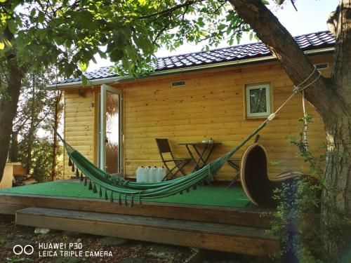 シオーフォクにあるCsillaghegyi Oázisの丸太小屋の玄関のハンモック