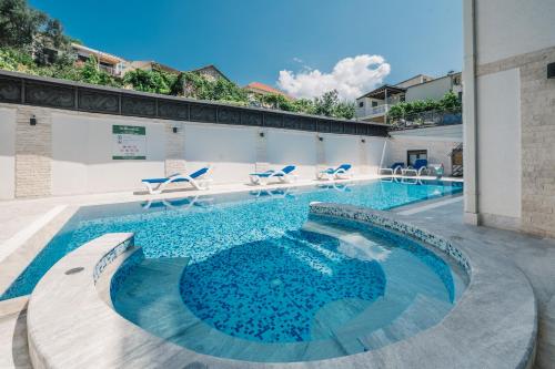 a swimming pool with blue water in a building at Barjaktar - Luxury Suites & SPA in Ulcinj