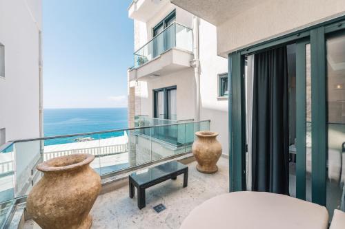 two vases sitting on a balcony with a view of the ocean at Barjaktar - Luxury Suites & SPA in Ulcinj