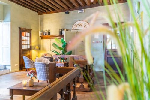 a dining room with tables and chairs and a refrigerator at Hotel Ter Brughe by CW Hotel Collection in Bruges