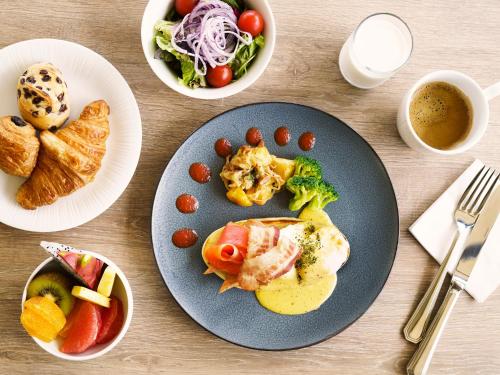 a table with a plate of food on a table at MB GALLERY CHATAN by THE TERRACE HOTELS in Chatan