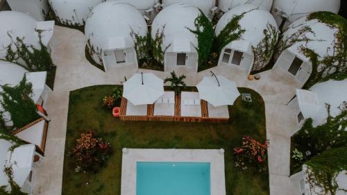an aerial view of a house and a swimming pool at Igloo Beach Lodge in Manuel Antonio