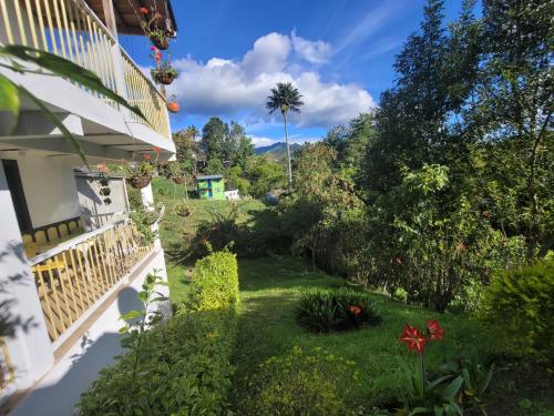 a garden outside a house with flowers and plants at La Posada de La Abuela Salento in Salento
