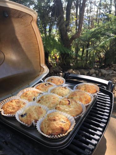 a bunch of muffins in paper cups on a grill at Golden Bay Glamping in Takaka