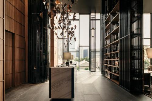 a tasting room with a large glass wall at The Clan Hotel Singapore by Far East Hospitality in Singapore