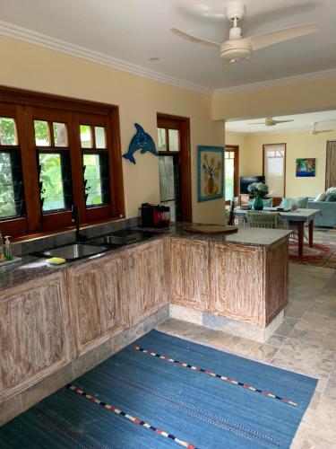 a kitchen with wooden counter tops and a living room at Beachfront Dolphin Cabin in Oak Beach