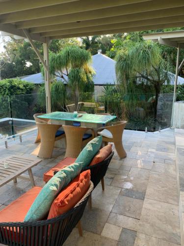 a patio with a table and chairs and a table at Beachfront Dolphin Cabin in Oak Beach