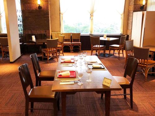 a dining room with a table with wine glasses on it at Hotel King in Izumi