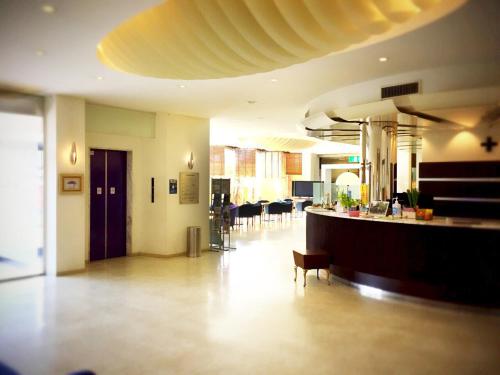 a lobby with a bar and chairs in a building at Hotel King in Izumi