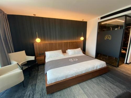 a hotel room with a bed and a chair at Golan Hotel in Tiberias