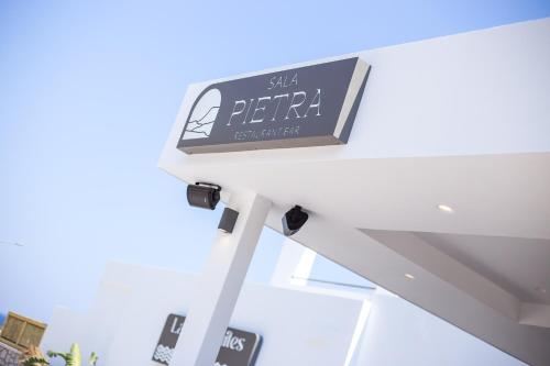 a sign sitting on top of a building at Ladiko Suites - Faliraki in Faliraki
