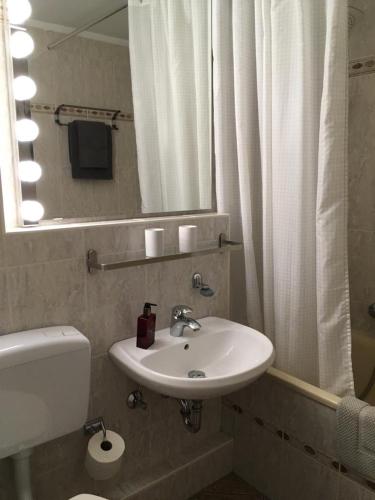 a bathroom with a sink and a toilet and a mirror at Seaside in Glücksburg