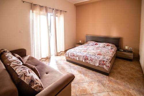 una camera con letto e divano di Petrovic apartmani a Tivat