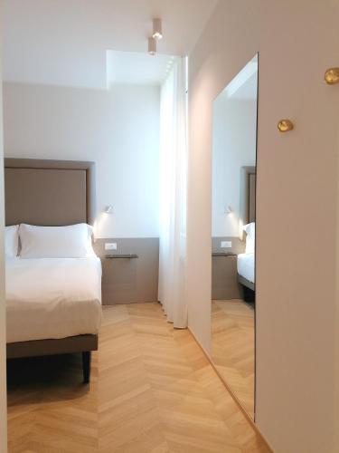 Letto o letti in una camera di Palazzo Cortesi