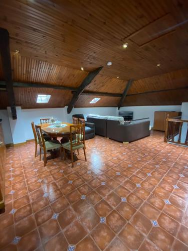 a room with a table and chairs and a couch at Casa pando 49 in Pando