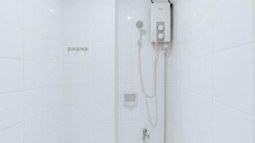 a shower with a hair dryer in a bathroom at RedDoorz near EDSA Camp Crame in Manila
