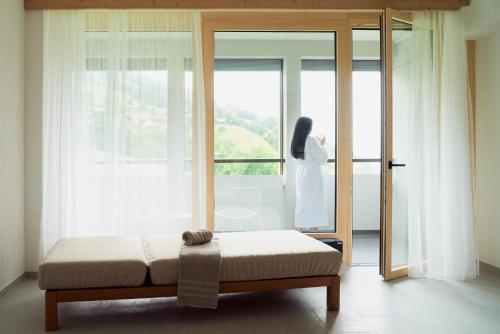 a bedroom with a bed in front of a window at Hotel Neu-Schönstatt in Quarten